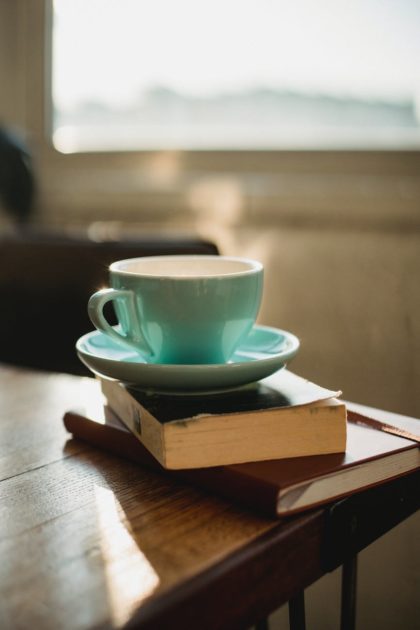 cup of hot beverage on books