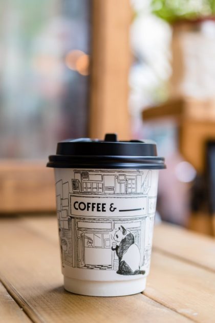 panda printed paper coffee cup on table